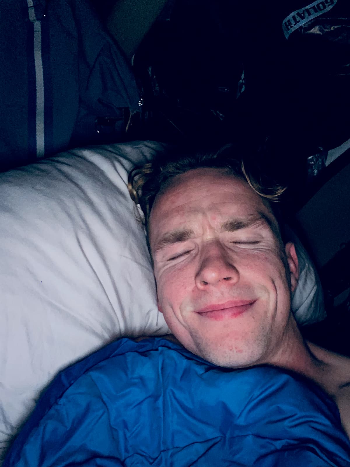 Sleeping in a blue sleeping bag on the first night living in the car
